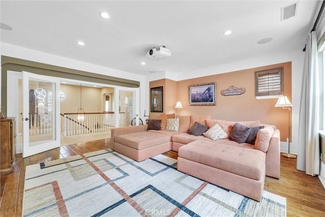 a living room with furniture and large windows