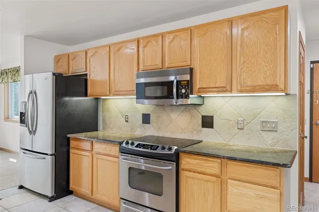 a kitchen with a stove a microwave and refrigerator