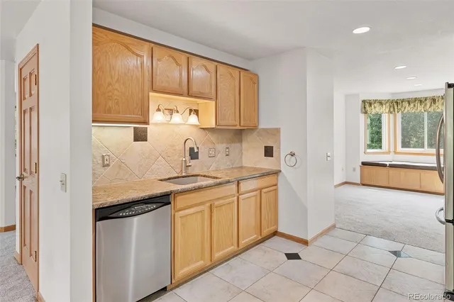 a kitchen with granite countertop a sink and a stove