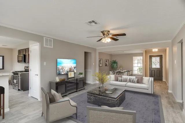 a living room with furniture and a chandelier