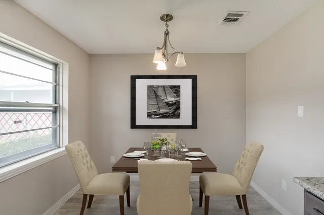 a dining room with furniture and window