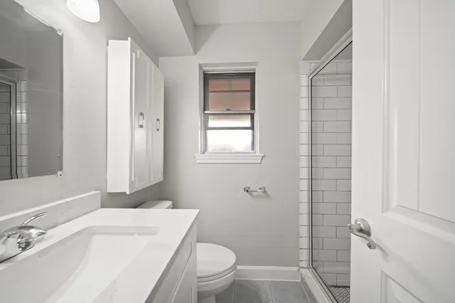 a bathroom with a sink toilet vanity and tub
