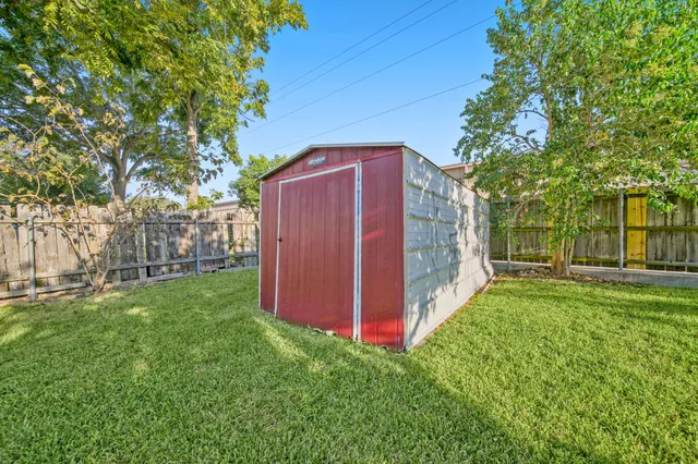 a view of a backyard with large trees