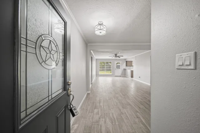 a view of empty room with wooden floor