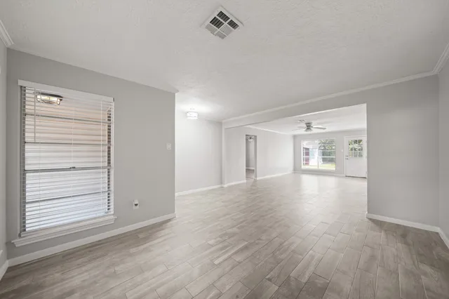 a view of a room with wooden floor and windows