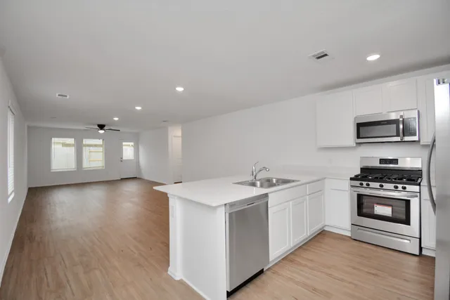 a kitchen with a sink and a stove top oven