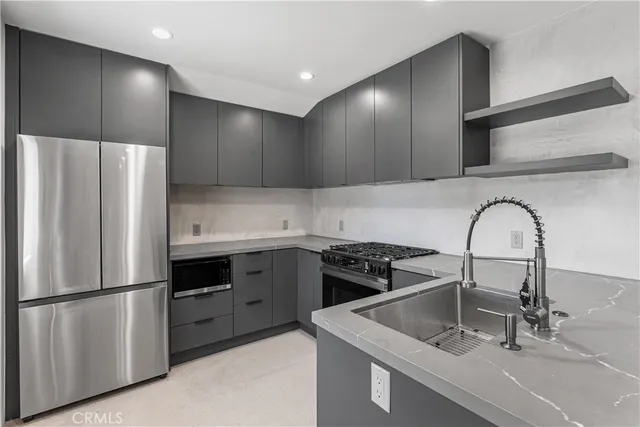 a kitchen with a stove a refrigerator and a sink