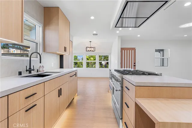 a kitchen with a sink stove and cabinets