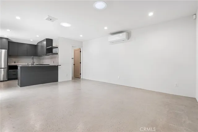 an empty room with a fireplace and entryway