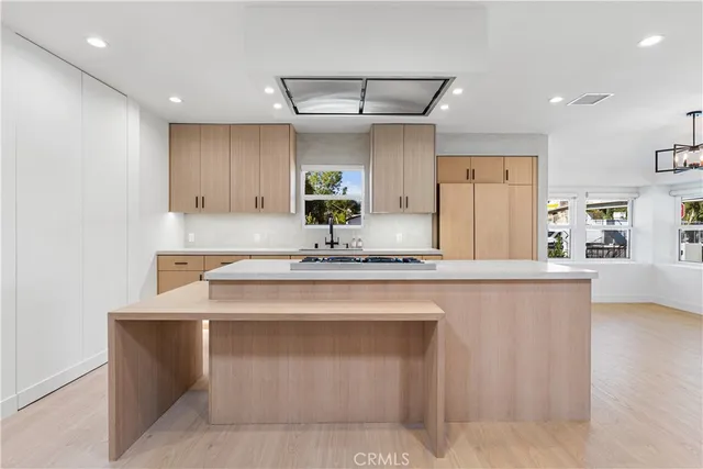 a kitchen with kitchen island a sink stainless steel appliances and cabinets