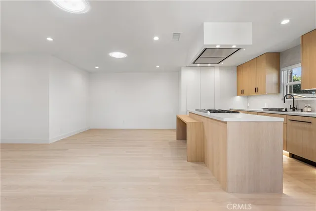 a kitchen with a refrigerator and a stove top oven