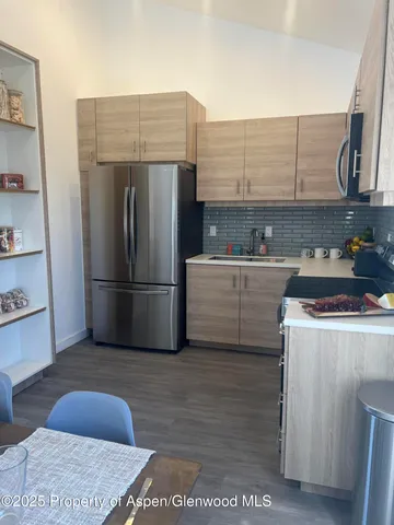 a kitchen with stainless steel appliances a refrigerator and a sink