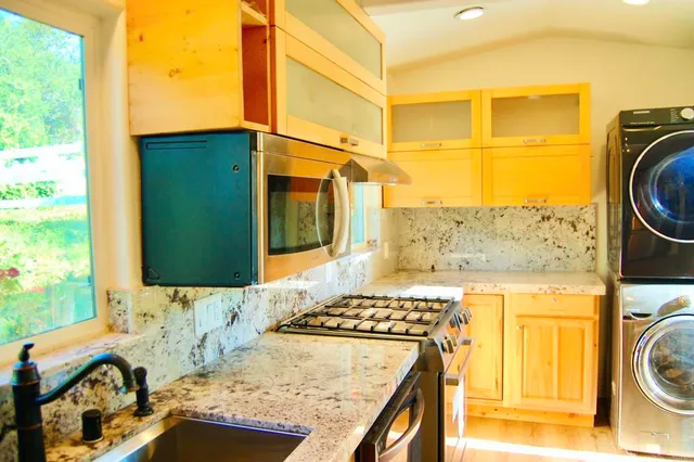 a bathroom with a granite countertop sink and a mirror