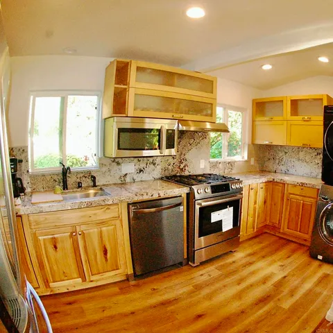 a kitchen with stainless steel appliances granite countertop a stove and a sink