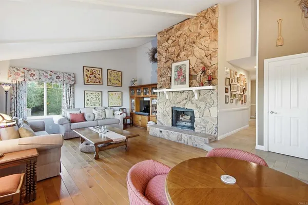 a living room with furniture a window and a clock