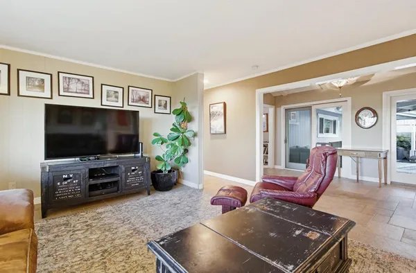 a kitchen with stainless steel appliances granite countertop a refrigerator a sink a stove a microwave and white cabinets