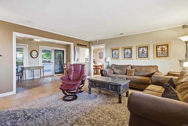 a kitchen with stainless steel appliances a stove a sink a microwave a dining table and chairs
