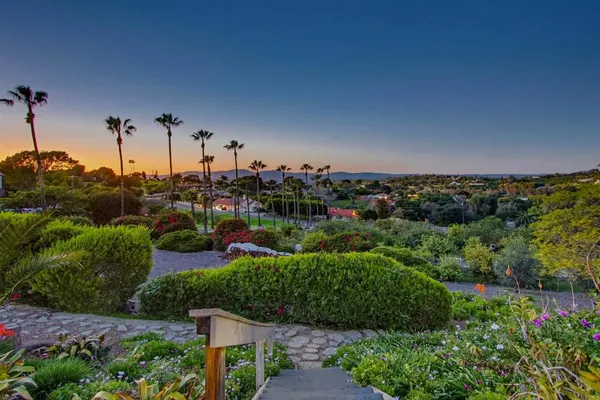 a view of a patio with table and chairs and potted plants