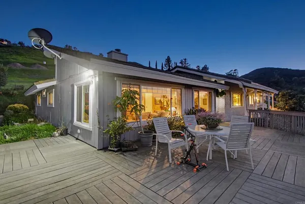 a living room with furniture large window and a fireplace