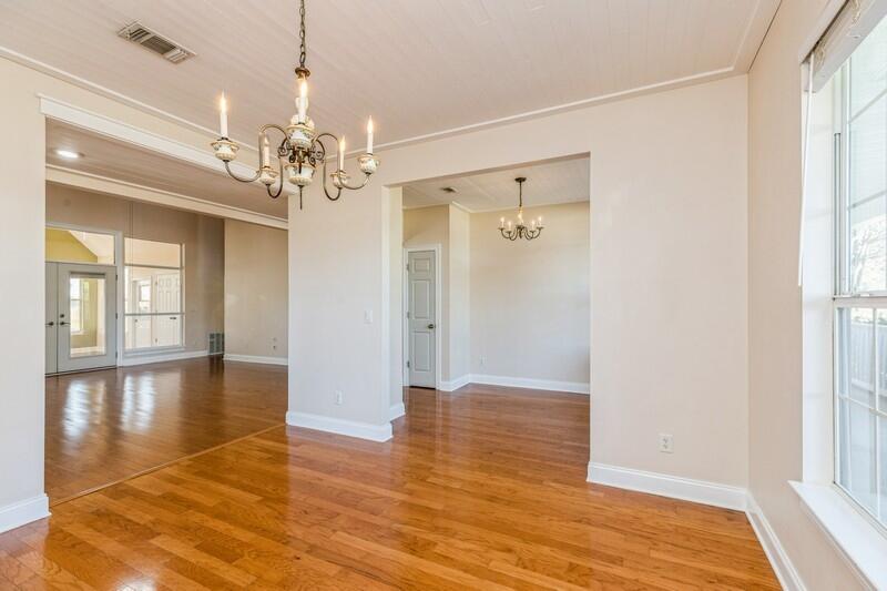 1510 Vinson Ray Road Baker, FL 32531 - Photo 11 of 60 a view of a hallway with wooden floor and a chandelier