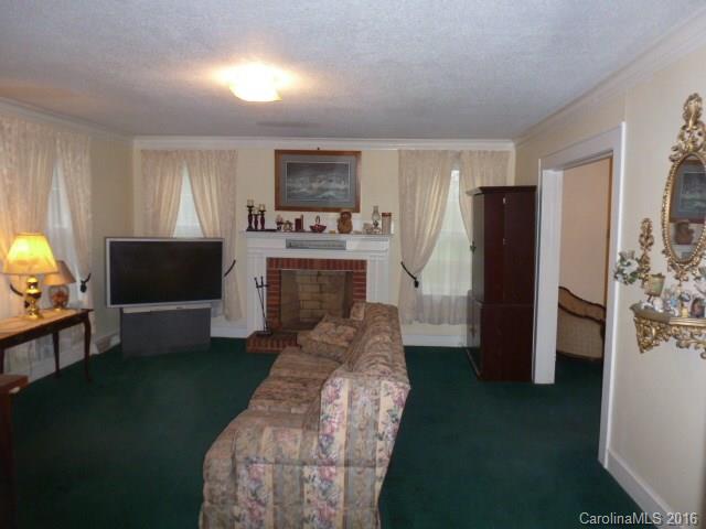 4852 Rowell Road Lancaster, SC 29720 - Photo 3 of 24 a living room with furniture a flat screen tv and a fireplace