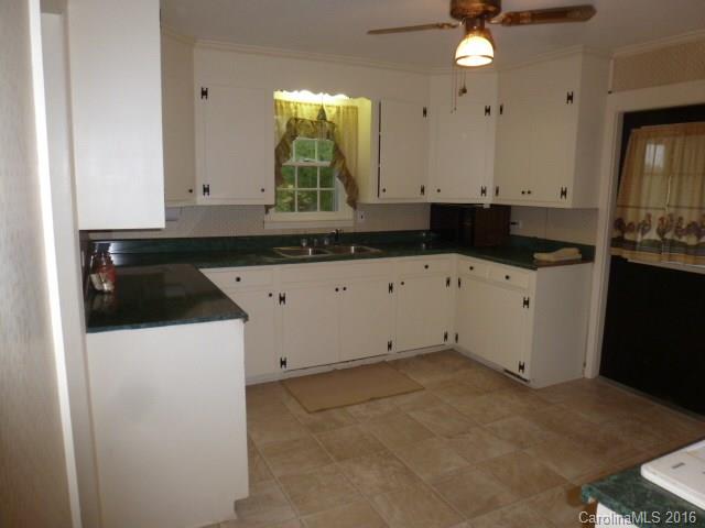 4852 Rowell Road Lancaster, SC 29720 - Photo 7 of 24 a kitchen with granite countertop white cabinets and sink