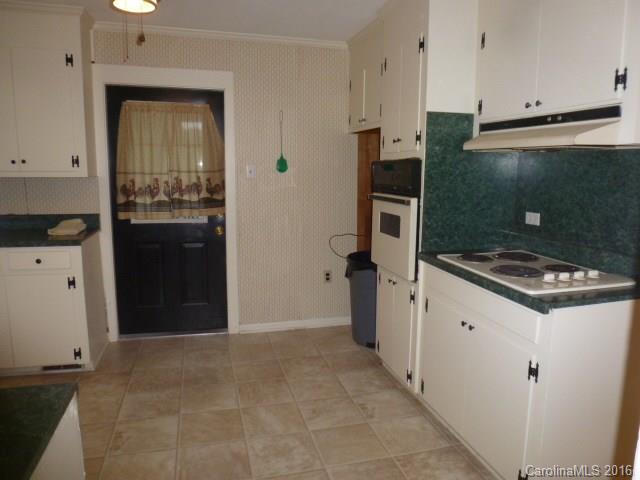 4852 Rowell Road Lancaster, SC 29720 - Photo 9 of 24 a kitchen with a refrigerator and a stove