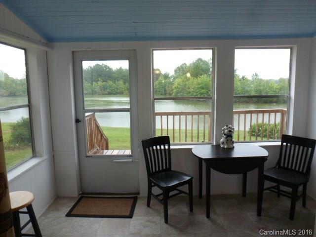 4852 Rowell Road Lancaster, SC 29720 - Photo 10 of 24 a dining room with furniture a rug and a floor to ceiling window