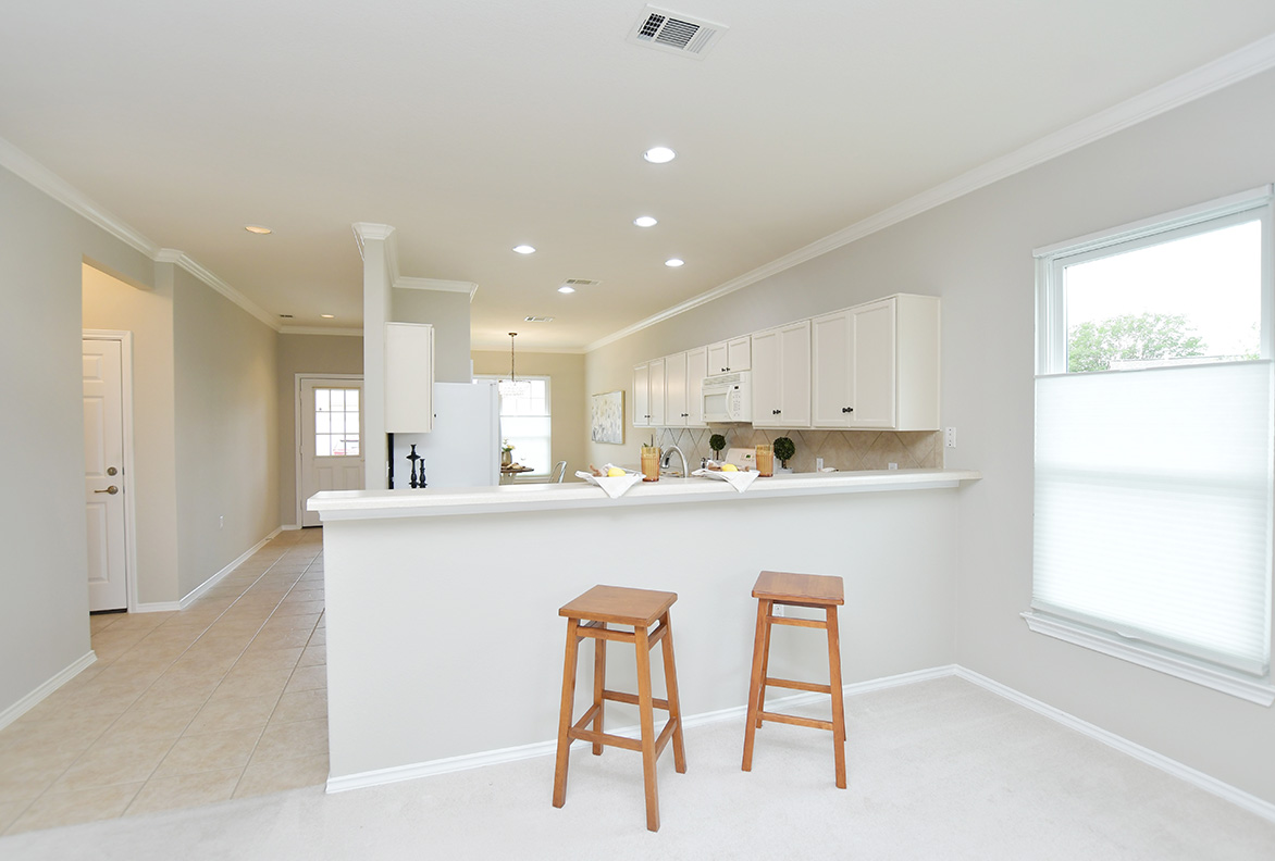 203 Winter Drive Georgetown, TX 78633 - Photo 10 of 29 A breakfast bar gently divides the kitchen from the living area, while maintaining openness.