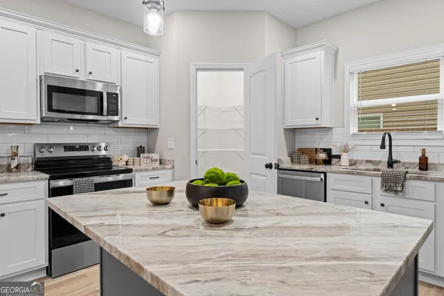 a kitchen with sink cabinets and window