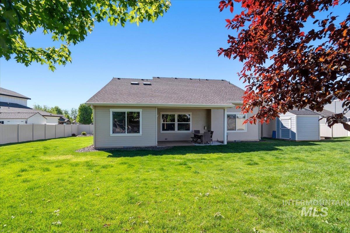1183 North Buffalo Way Middleton, ID 83644 - Photo 38 of 47 Expansive green lawn with a covered patio area and a visible storage shed