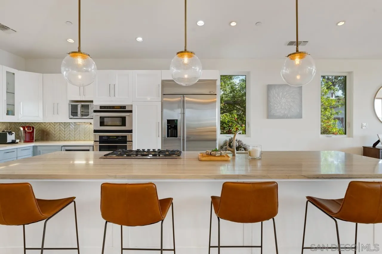 733 Stratford Drive Encinitas, CA 92024 - Photo 18 of 46 a kitchen with stainless steel appliances granite countertop a kitchen island a stove and a sink
