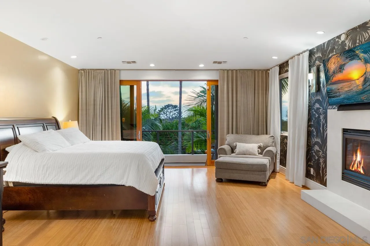 733 Stratford Drive Encinitas, CA 92024 - Photo 25 of 46 a bedroom with a bed and a flat screen tv