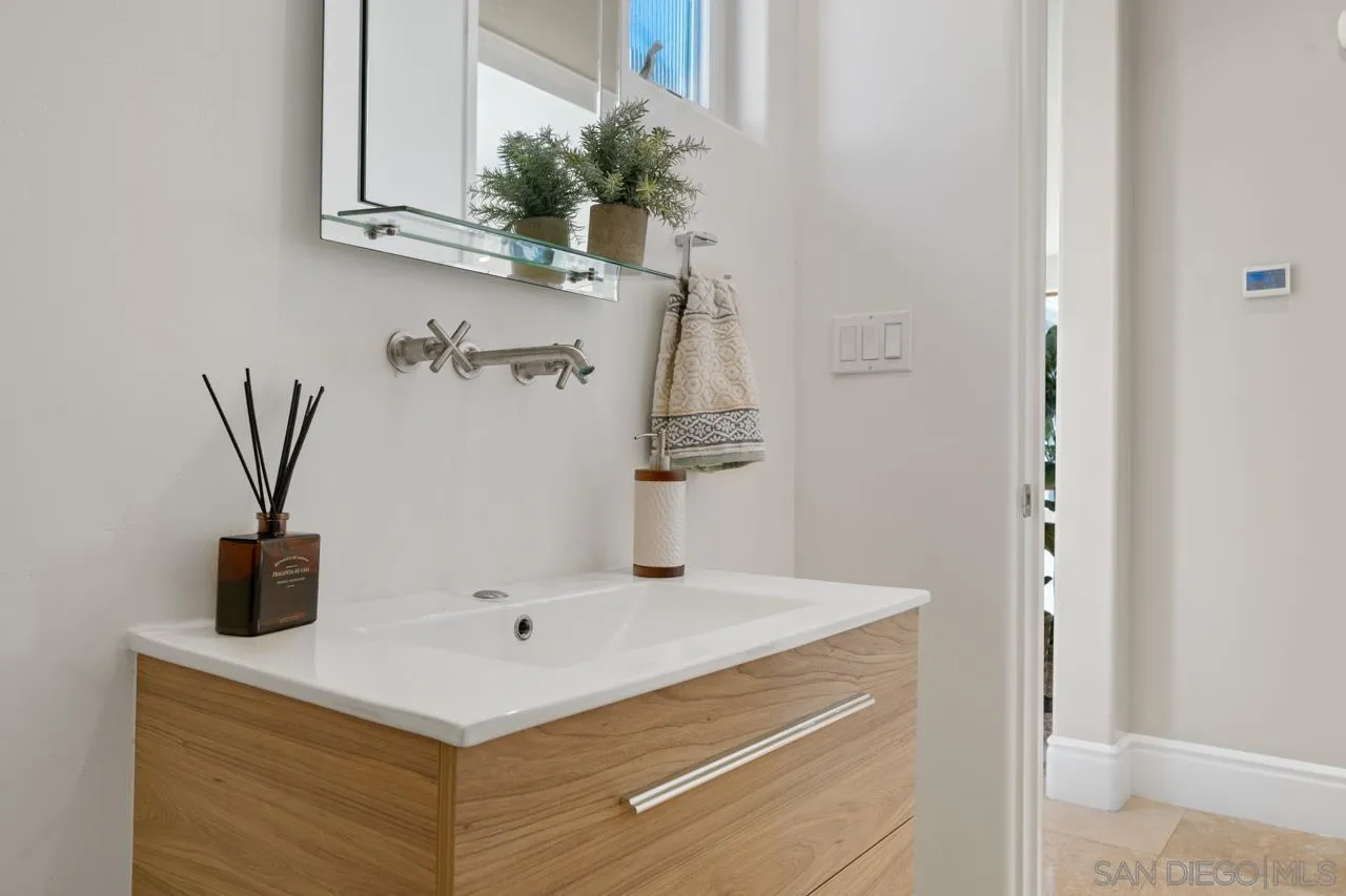 733 Stratford Drive Encinitas, CA 92024 - Photo 32 of 46 a bathroom with a sink and a mirror