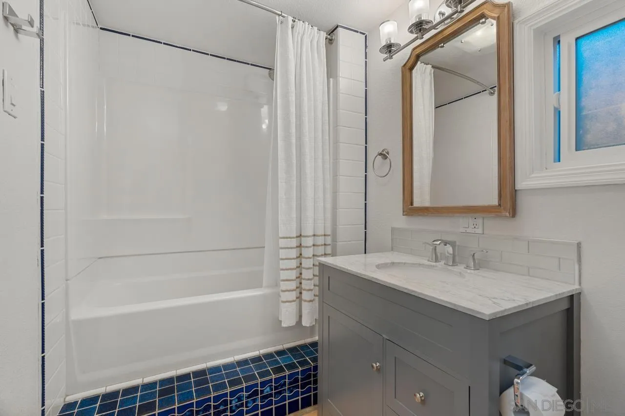 733 Stratford Drive Encinitas, CA 92024 - Photo 43 of 46 a bathroom with a sink a mirror and a bathtub