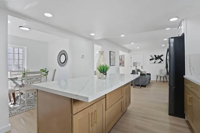 a bedroom with a bed and a wall painting