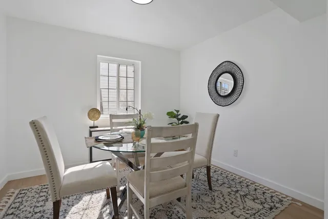 a bedroom with a bed and a lamp on dresser