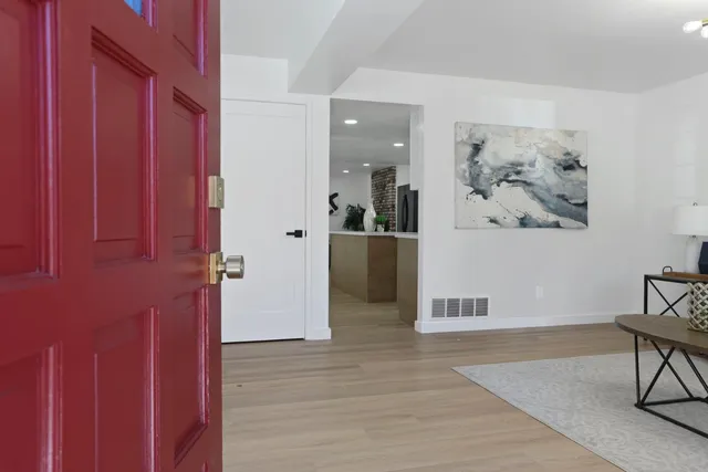 a kitchen with stainless steel appliances granite countertop a refrigerator a sink and a stove