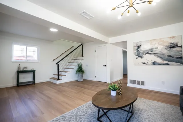 a living room with furniture and a wooden floor
