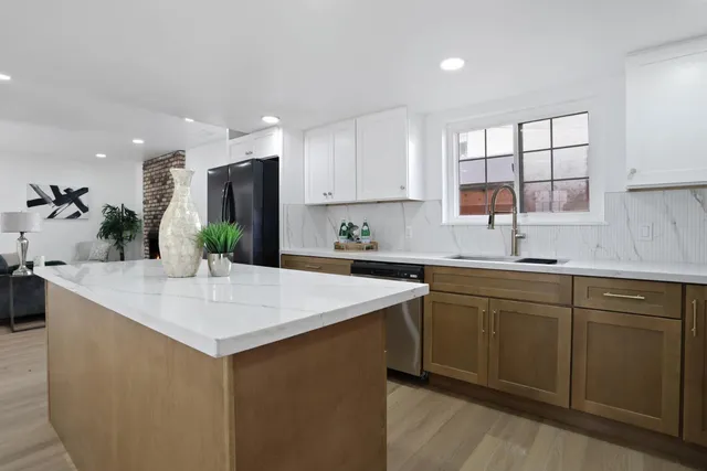 a view of a room with furniture and wooden floor