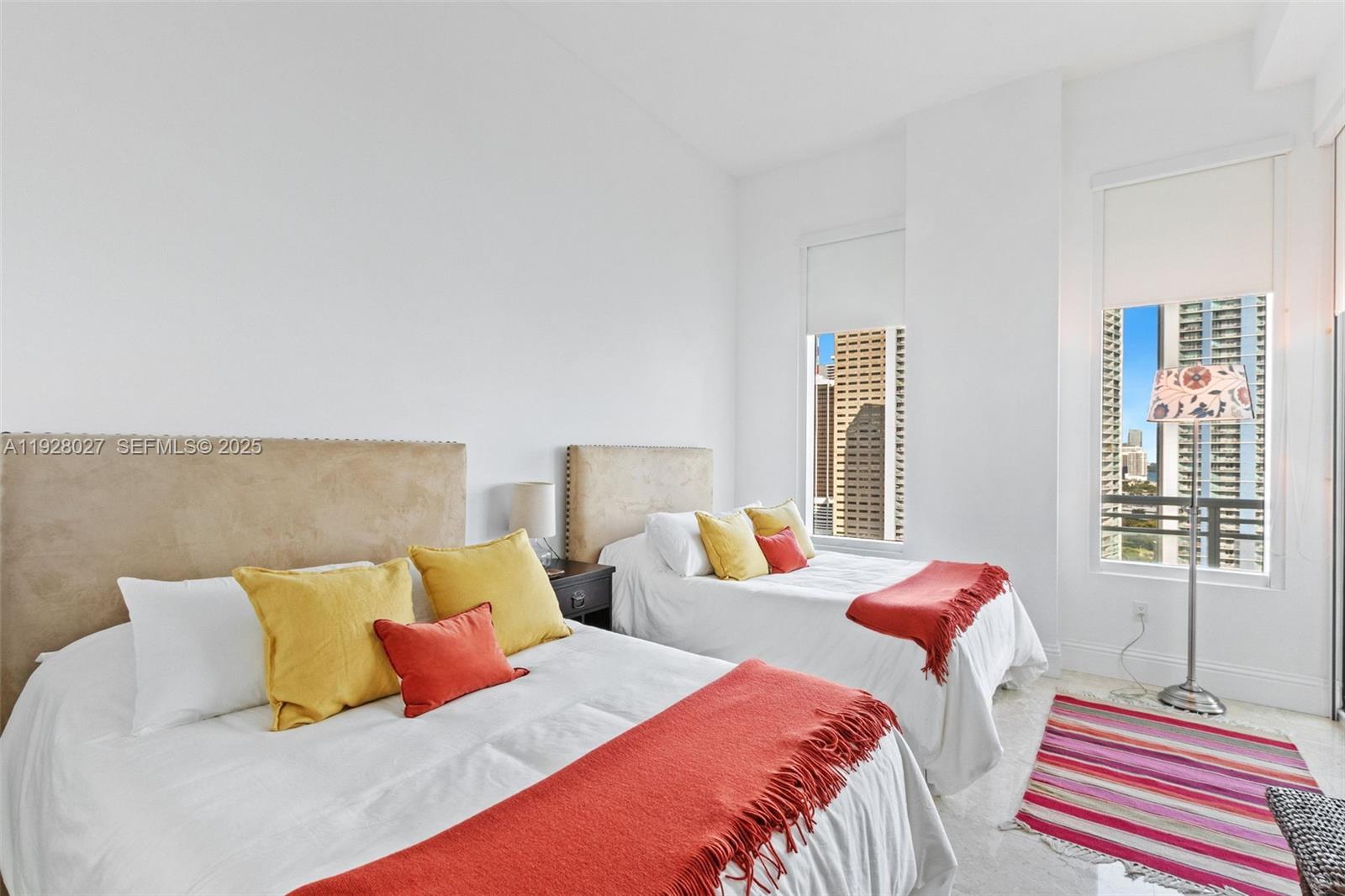 900 Brickell Key Boulevard, Unit 2002 Miami, FL 33131 - Photo 13 of 28 a bedroom with two beds and a couch