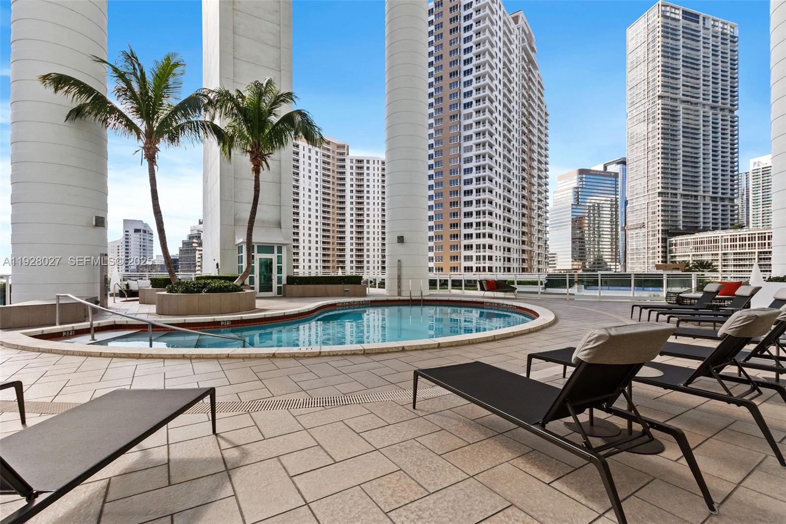 900 Brickell Key Boulevard, Unit 2002 Miami, FL 33131 - Photo 17 of 28 a view of a swimming pool with chairs