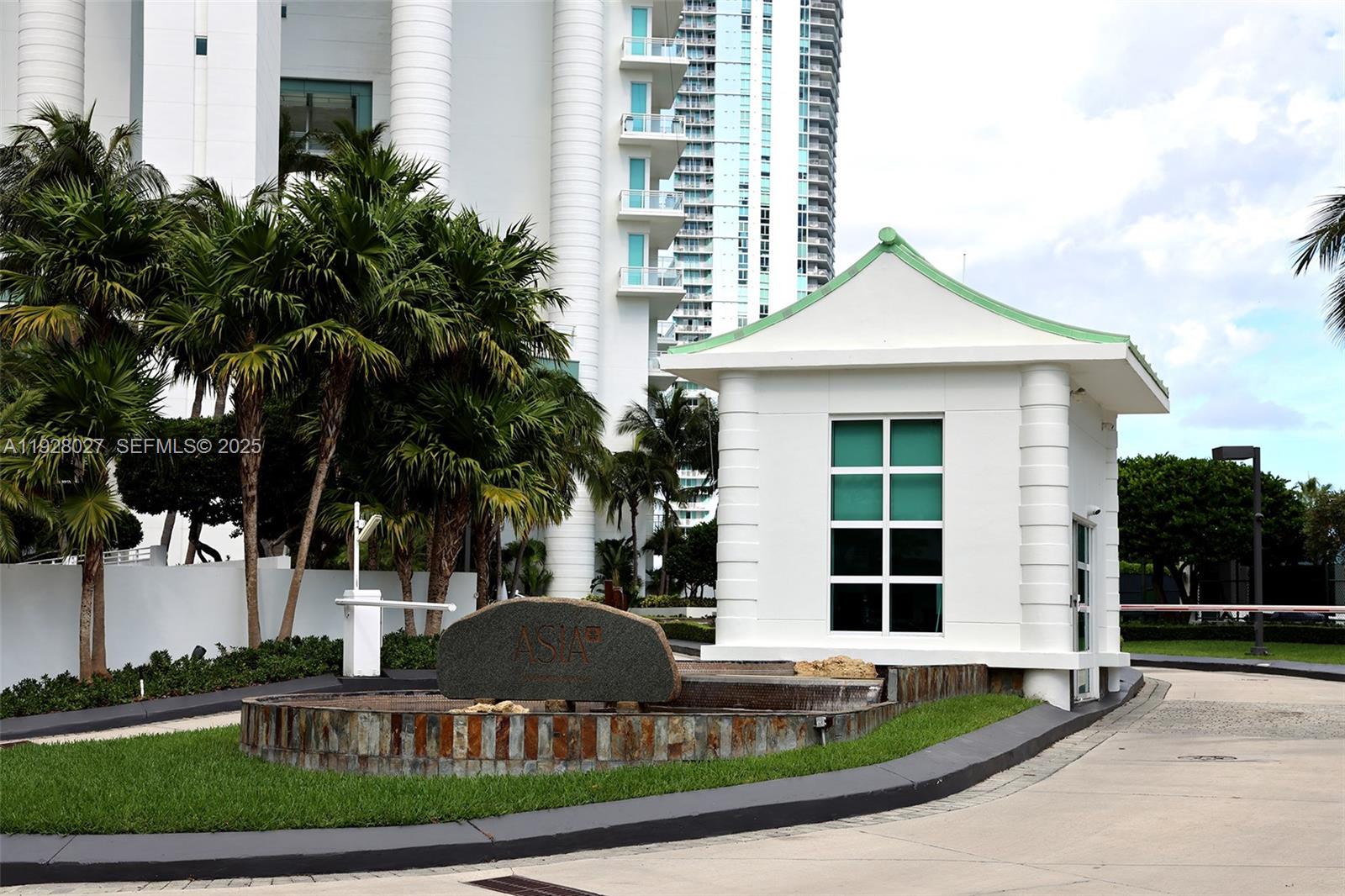 900 Brickell Key Boulevard, Unit 2002 Miami, FL 33131 - Photo 22 of 28 a front view of a house with a yard and garage