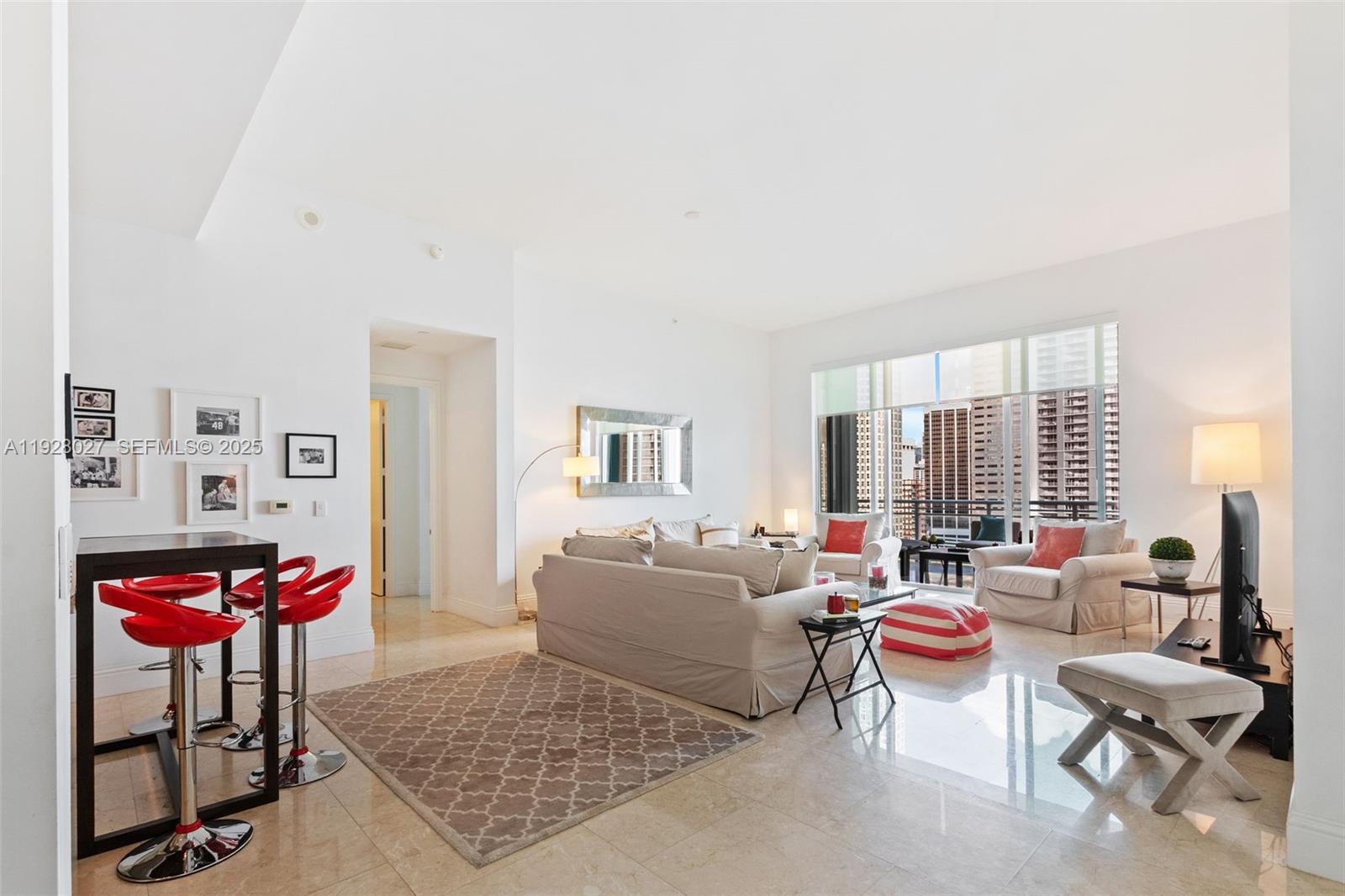 900 Brickell Key Boulevard, Unit 2002 Miami, FL 33131 - Photo 6 of 28 a living room with furniture and a rug