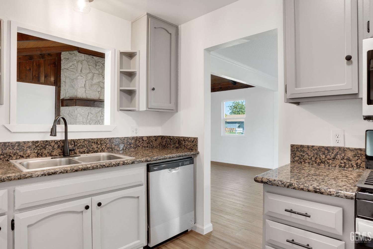 Undisclosed Address Bakersfield, CA 93312 - Photo 11 of 29 a kitchen with granite countertop a sink and a stove
