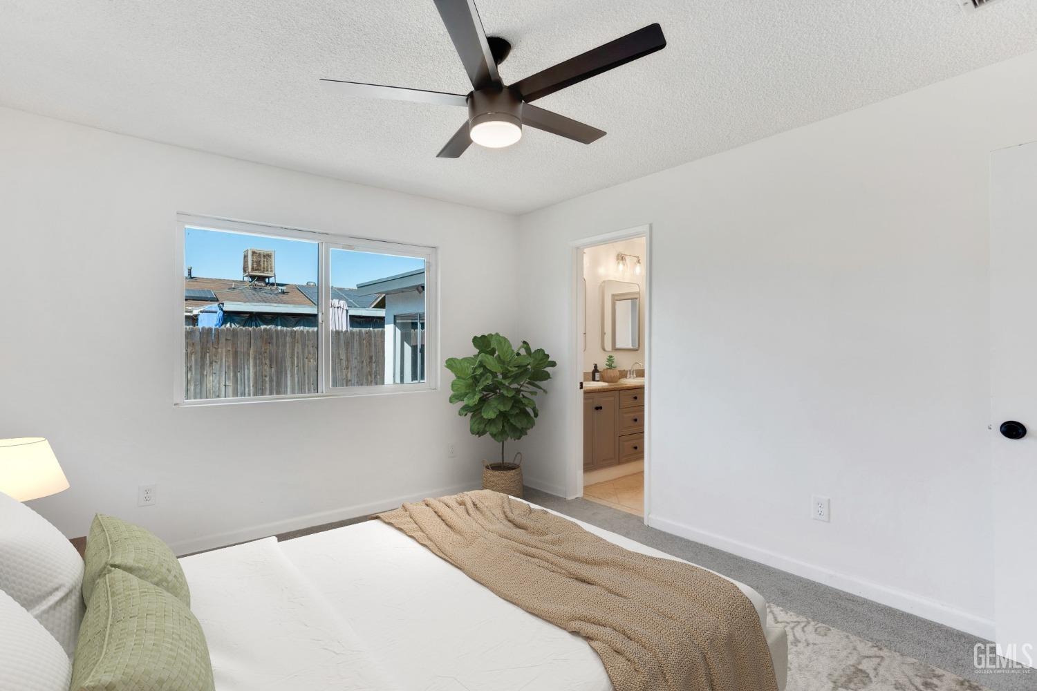 Undisclosed Address Bakersfield, CA 93312 - Photo 15 of 29 a bedroom with a bed and a potted plant