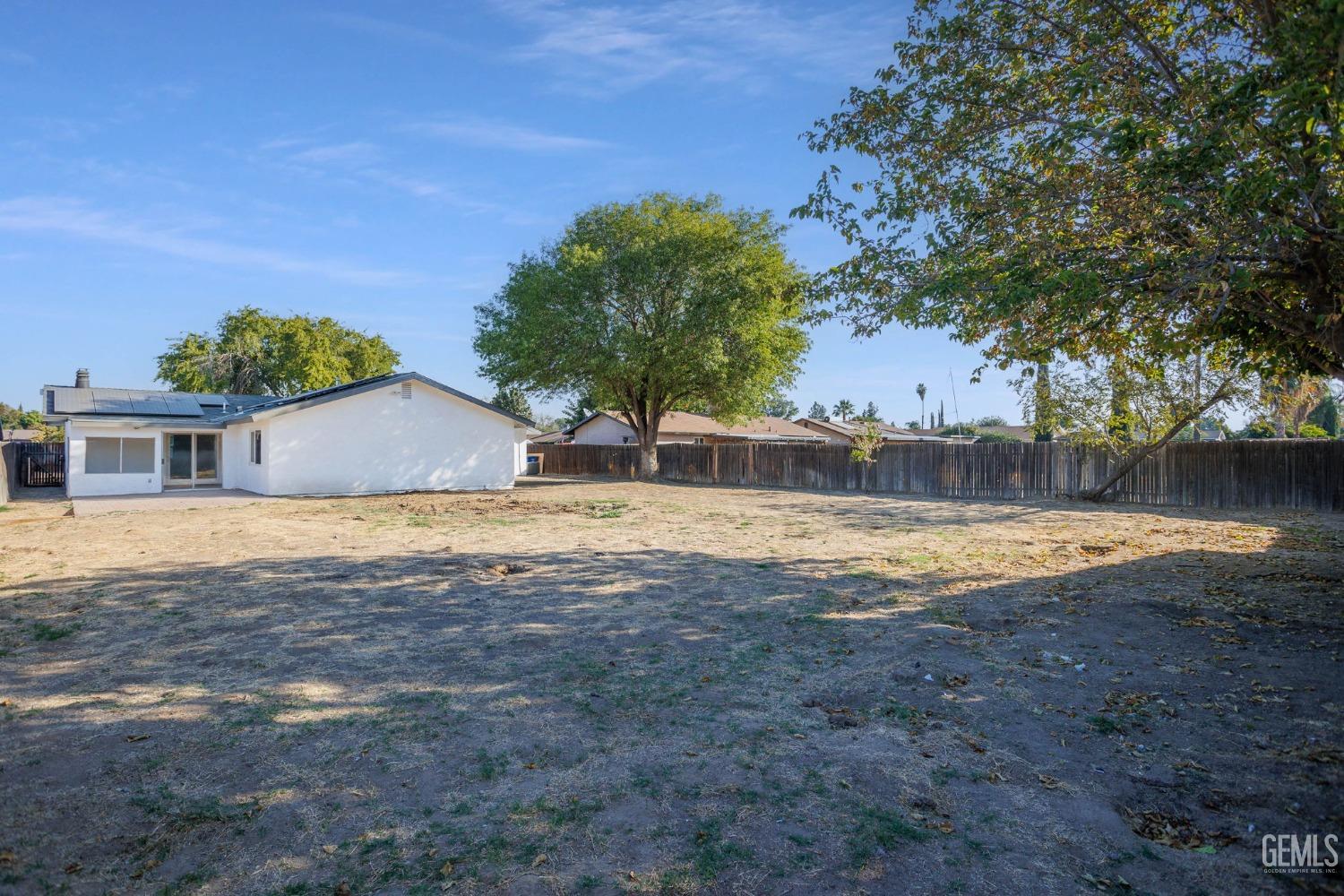 Undisclosed Address Bakersfield, CA 93312 - Photo 24 of 29 a view of pool with large trees and a big yard