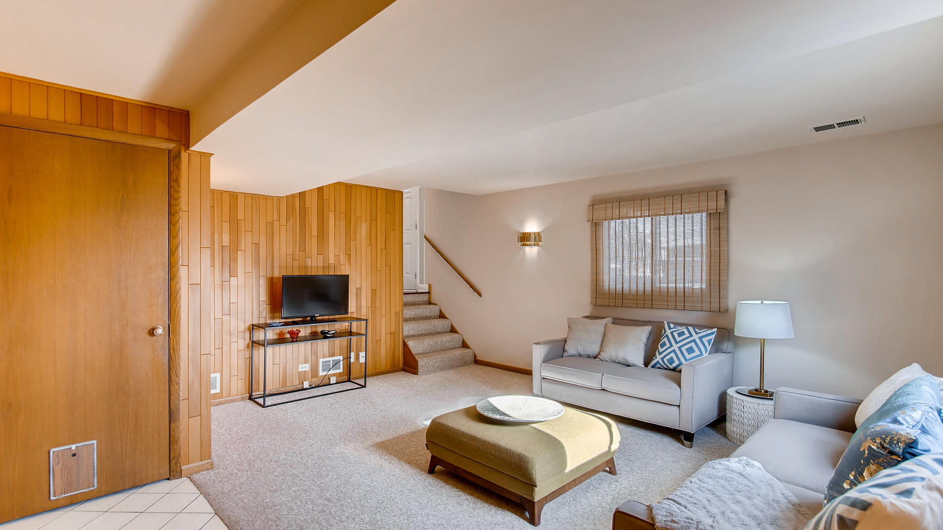 1229 Honey Hill Road Addison, IL 60101 - Photo 16 of 25 a living room with furniture and a flat screen tv