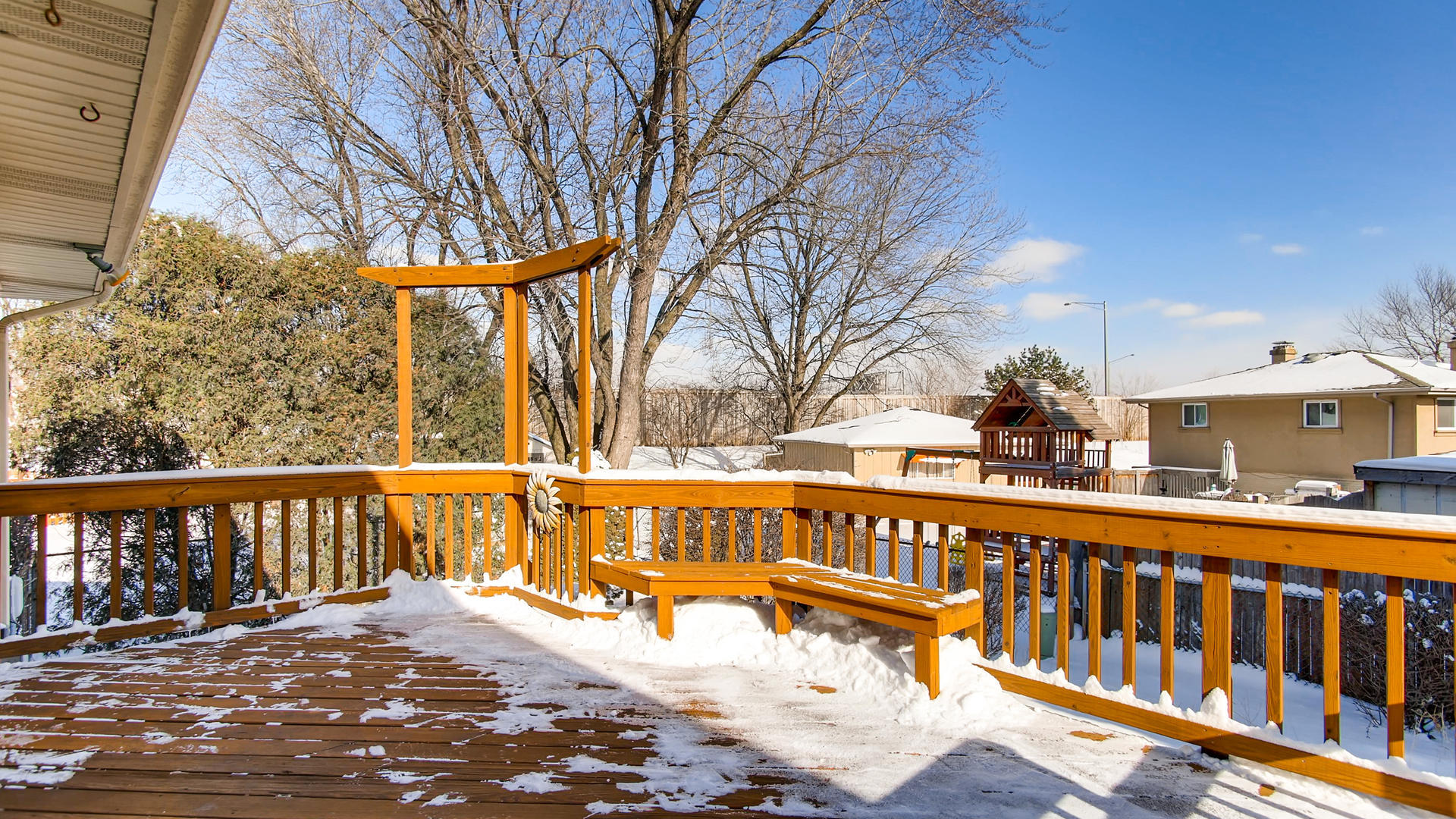 1229 Honey Hill Road Addison, IL 60101 - Photo 20 of 25 a view of a balcony with wooden fence and large trees
