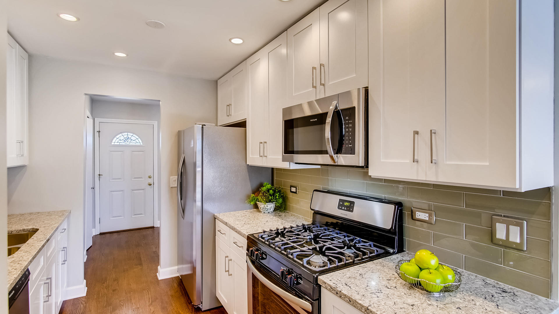 1229 Honey Hill Road Addison, IL 60101 - Photo 6 of 25 a kitchen with stainless steel appliances granite countertop a stove a refrigerator and a microwave